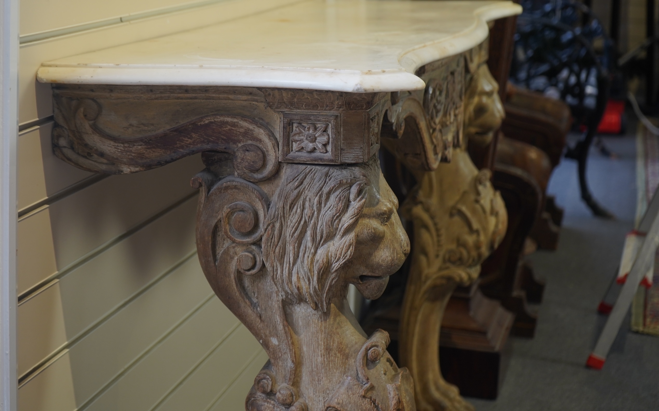 A 19th century Baroque style marble topped limed oak serpentine console table